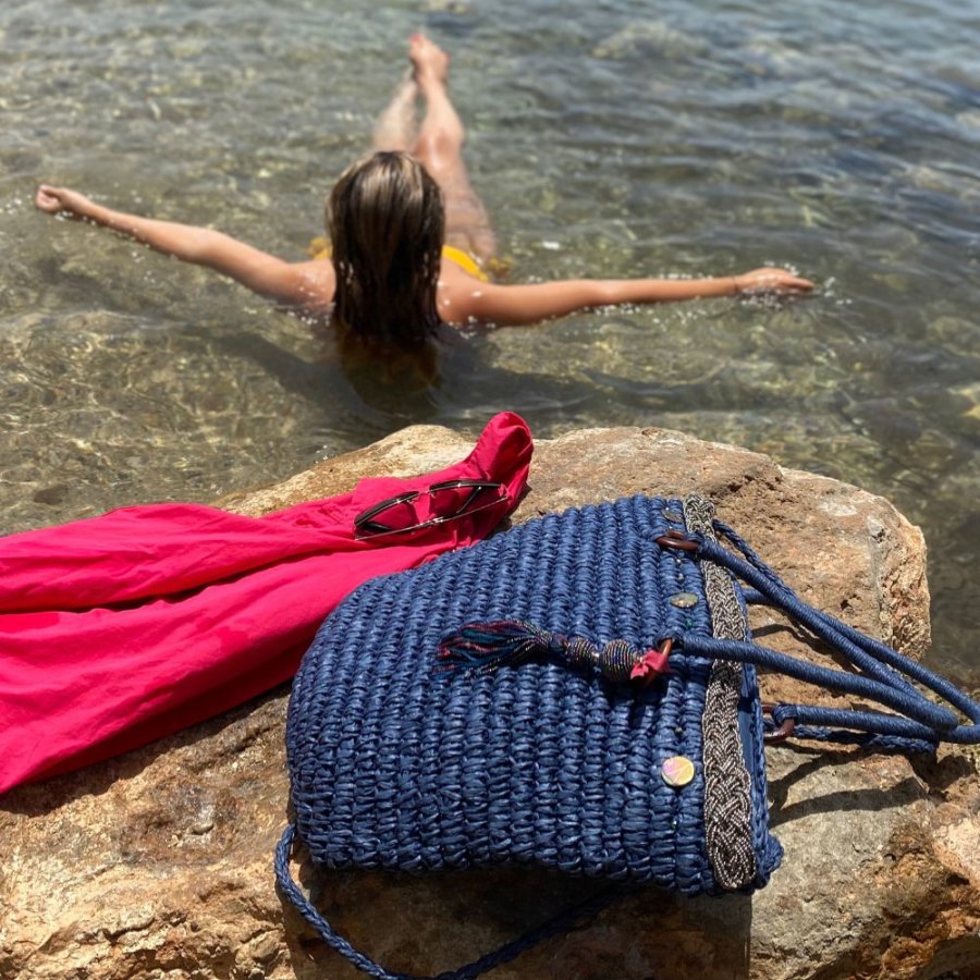 This beach tote bag is made from raffia and is hand embellished with pearled braid, crystal pearls, shells and pearled pom pom.