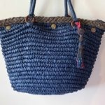 This beach tote bag is made from raffia and is hand embellished with pearled braid, crystal pearls, shells and pearled pom pom.