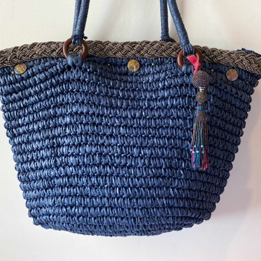This beach tote bag is made from raffia and is hand embellished with pearled braid, crystal pearls, shells and pearled pom pom.