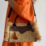 Add a unique twist to your outfit with this stunning straw handbag. Hand–embellished with pearled, sequinned silk and a bright orange pom pom. Carry it as a cross body to keep your hands free, or switch to the handle for a more traditional look.
