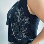 This unique sleeveless cotton vest from Oued Soya@'s classy collection is hand-embellished with black and silver details and brooches.