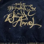 This dark gray denim jacket s part of Oued Soya@'s unique street wear collection. Hand embellished with golden calligraphy.